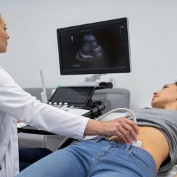 Doctor performing an abdominal ultrasound on a patient