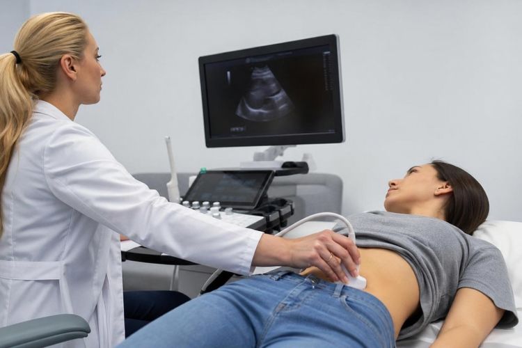 Doctor performing an abdominal ultrasound on a patient