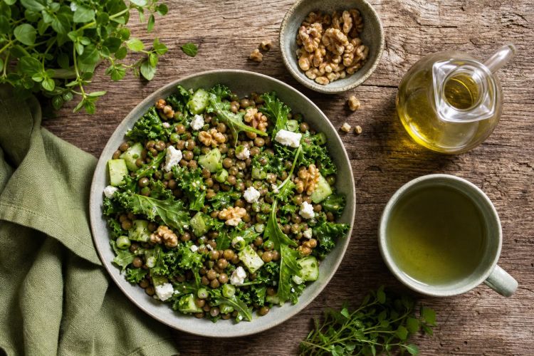Green Mediterranean meal with lentil salad, leafy greens, walnuts, olive oil and green tea