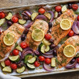 Sheet-pan salmon fillets with lemon, cherry tomatoes, zucchini and olives
