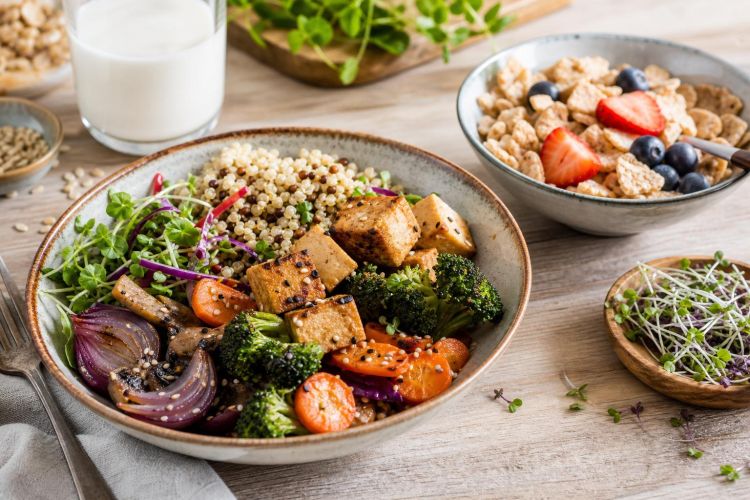 Vegan grain bowl with tofu and vegetables, plant-based milk and fortified cereal