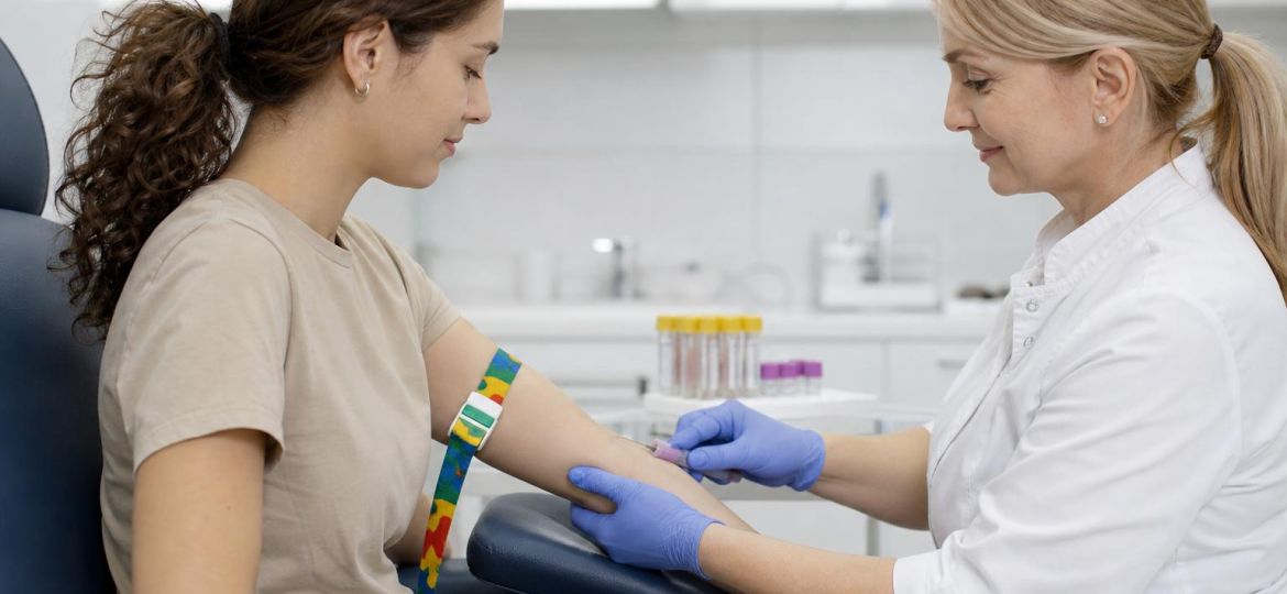 Phlebotomist drawing blood for a cholesterol test